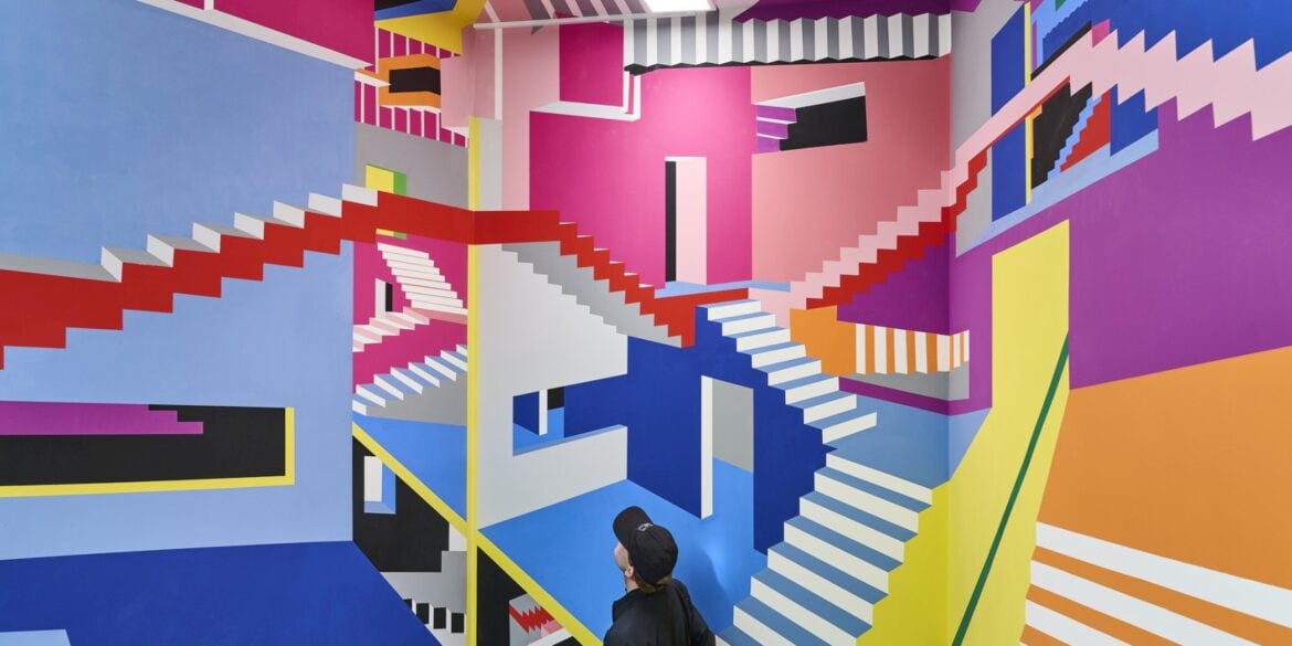 A colorful mural at the Wow Museum in Munich that resembles a drawing by M. C. Escher