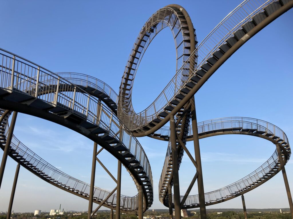 The Tiger & Turtle mine dump sculpture in Duisburg with a blue sky in the background