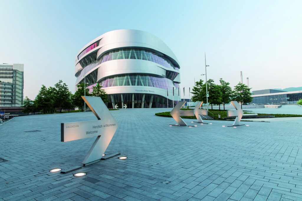 A round silver building with a window façade that spirals upwards