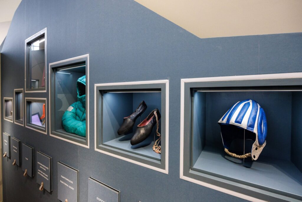 Close-up of some exhibits in the Alpine Museum in Munich, including a helmet and climbing shoes