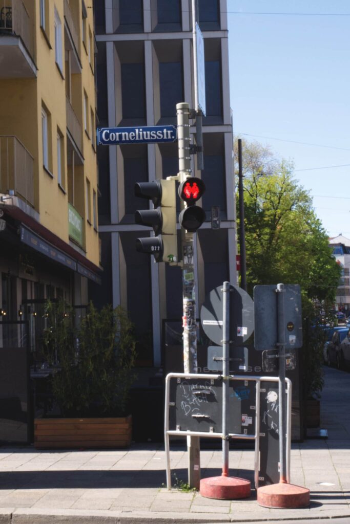 A pedestrian light shows a same-sex couple in the red signal