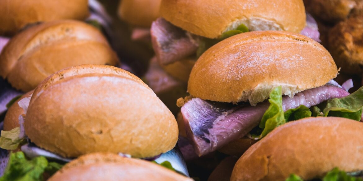 Several fish sandwiches, a regional specialty from Germany, are lined up next to each other.