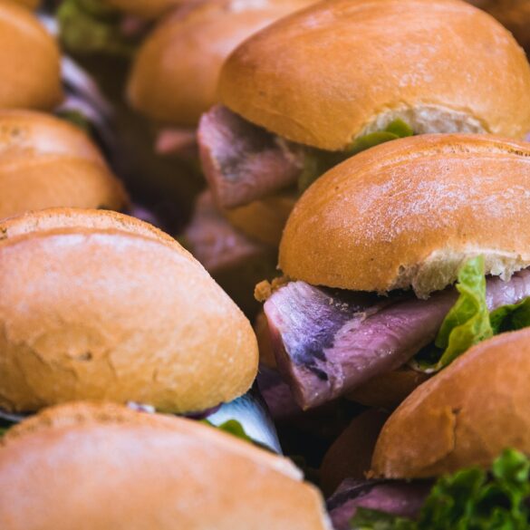 Several fish sandwiches, a regional specialty from Germany, are lined up next to each other.