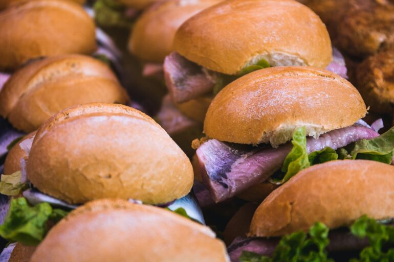 Several fish sandwiches, a regional specialty from Germany, are lined up next to each other.