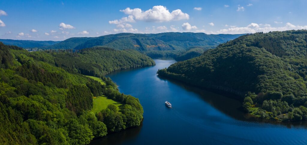 Boat sailing across Lake Rursee in the Eifel region