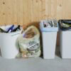 Four different trash cans in a row