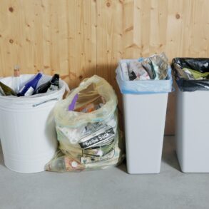 Four different trash cans in a row
