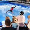 A person surfs on an artificial wave at Citywave Freiburg.