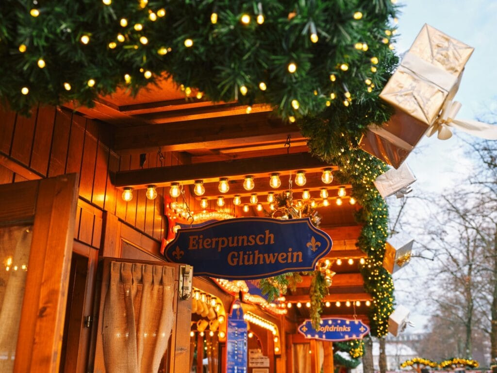 A sign at a christmas market hut saying "Eierpunsch - Glühwein"