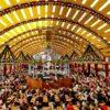 Panoramic view of a festival tent at Oktoberfest in Munich. Every table is full of people.