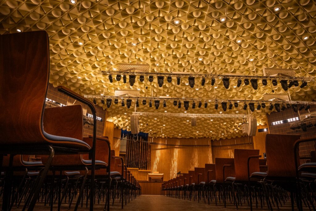 The Beethovenhalle in Bonn, featuring an acoustically treated ceiling and wooden wall paneling.