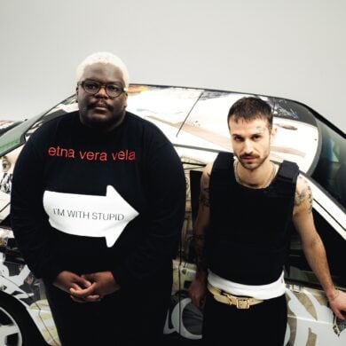 The german duo "Blumengarten" at a video shooting, standing in front of a car painted with graffiti