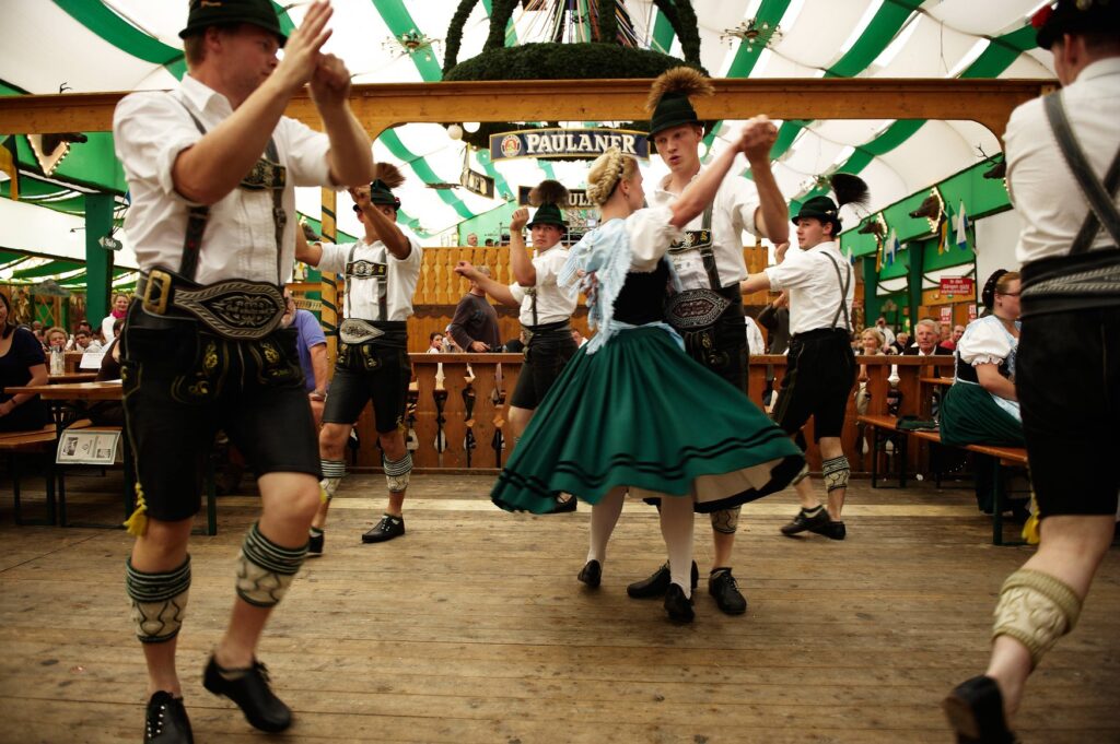 Couples in lederhosen and dirndl turn on the dance floor of a beer tent at the Oide Wiesn.